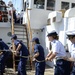 Teamwork heaving a line to hoist the main sail aboard Coast Guard Barque