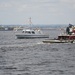 A US Naval Academy Yard Patrol craft passes alongside a Moran Towing Company tugboat