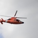 A Coast Guard MH-65C Dolphin helicopter patrols the waterways in and surrounding the Port of Baltimore during the Bicentennial of the War of 1812