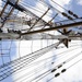 Coast Guardsmen work aloft above the deck aboard Coast Guard Barque Eagle