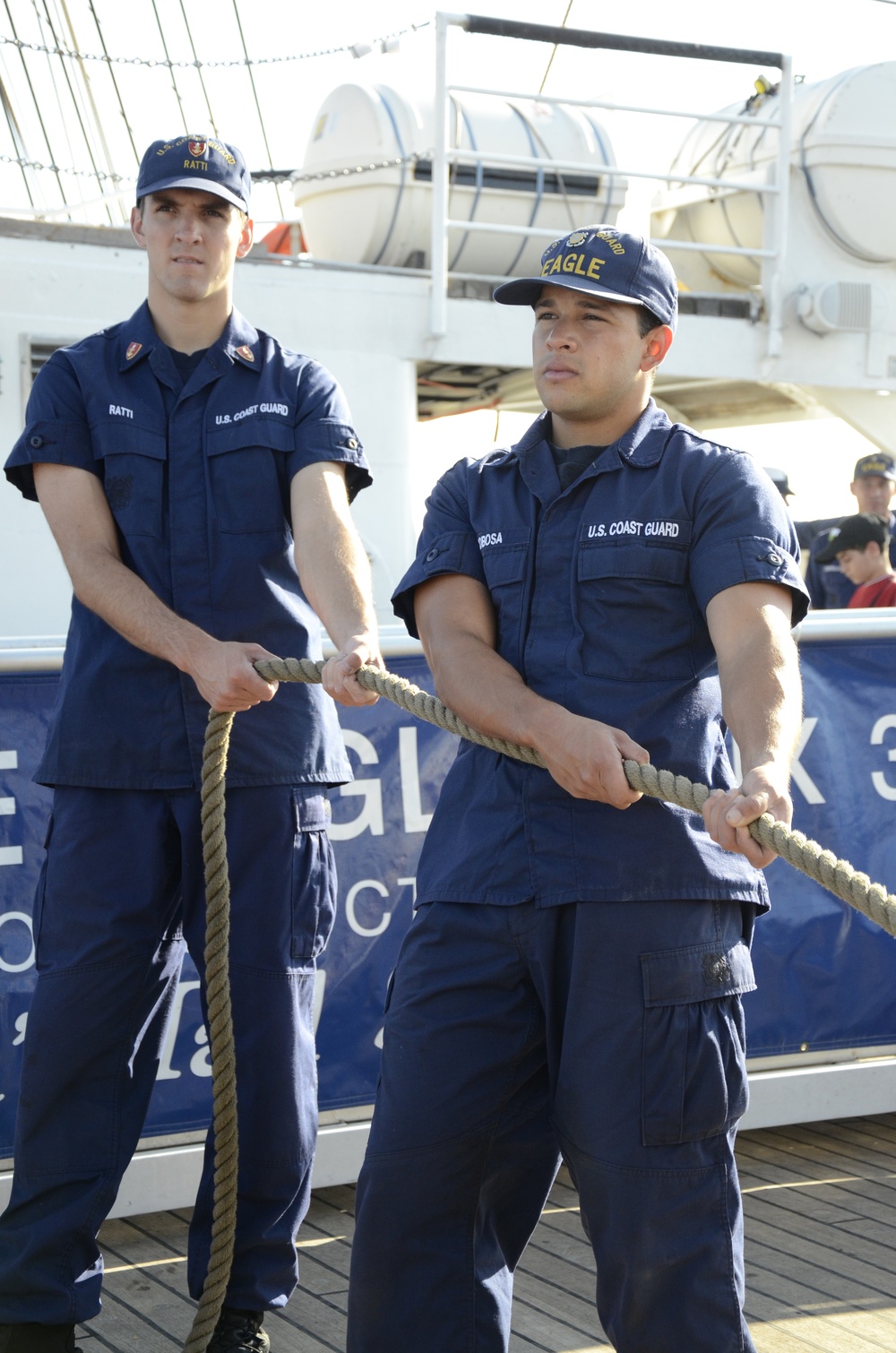 Two Coast Guard Academy cadets aboard US Coast Guard Barque Eagle (WIX 327) take tension on a mooring line