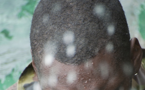 A member of the Barbados Defense Force takes a break after perform vessel debarkation drills during Exercise Tradewinds 2012