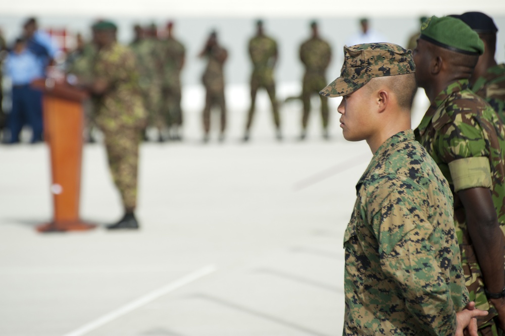 Marine Corps Cpl. Johnny Tau stands at attention as he awaits the command to unfurl the American flag during the opening ceremony for Exercise Tradewinds 2012