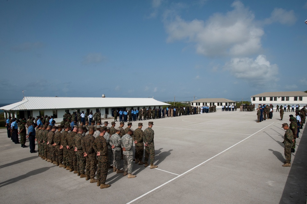 Service members from multiple nations bow their heads during the opening invocation at Exercise Tradewinds 2012