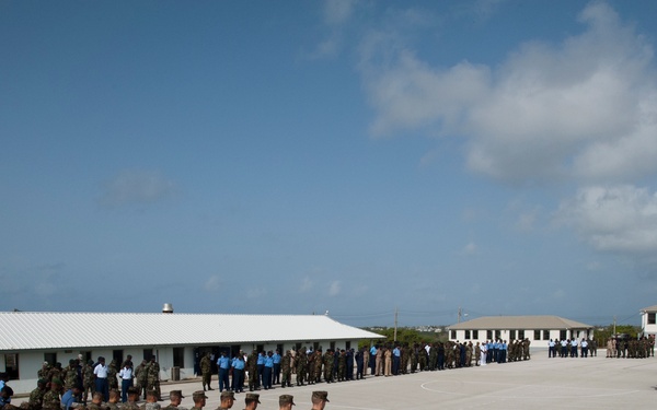 Service members from multiple nations bow their heads during the opening invocation at Exercise Tradewinds 2012