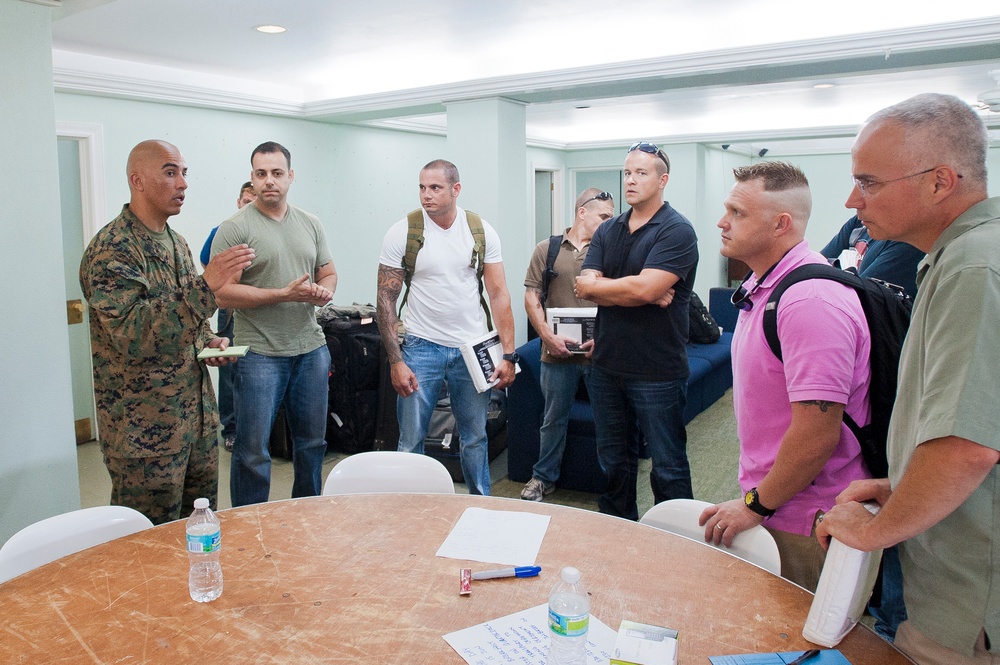 Marine Corps Gunnery Sgt. Jose Marquez briefs a group of newly arrived Coast Guardsmen about the barracks rules and regulations during Exercise Tradewinds 2012