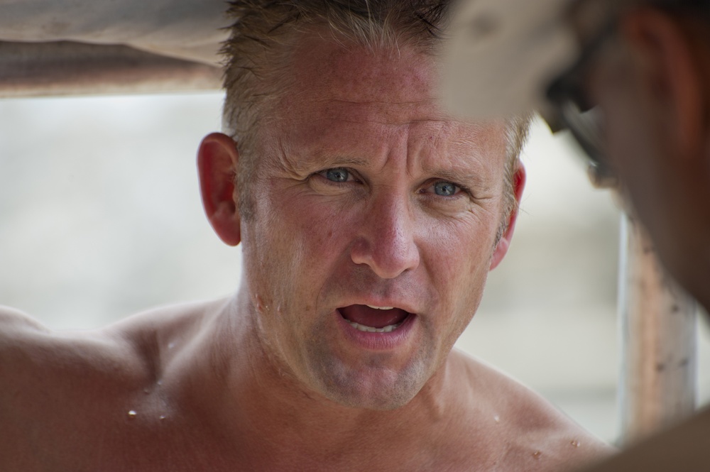 Canadian Navy Chief Petty Officer 2nd Class Andy Tiffin talks to Petty Officer 1st Class Ricky Vemb about his last dive during Exercise Tradewinds 2012