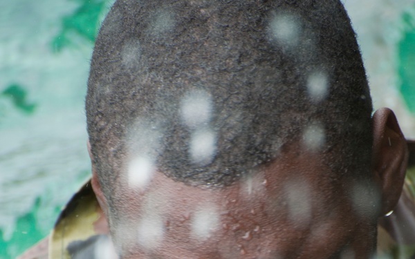 A member of the Barbados Defence Force takes a break after perform vessel debarkation drills during Exercise Tradewinds 2012