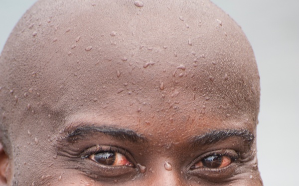 A member of the Barbados Defence Force takes a break after perform vessel debarkation drills during Exercise Tradewinds 2012