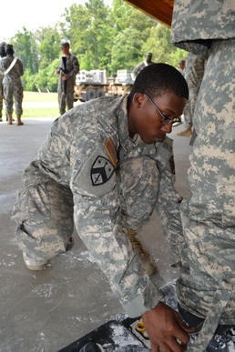 Helping decontaminate a soldier