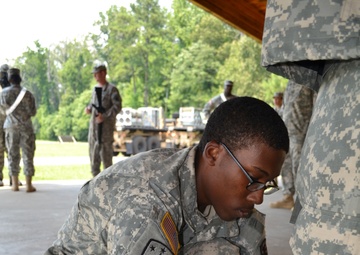 Helping decontaminate a soldier