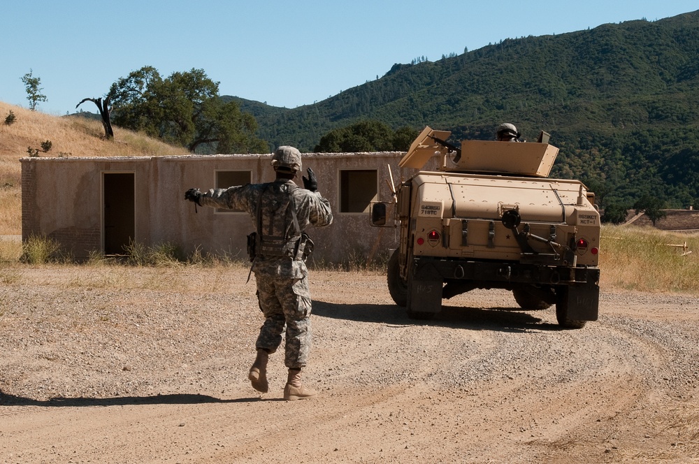 Reservist guides Humvee during training