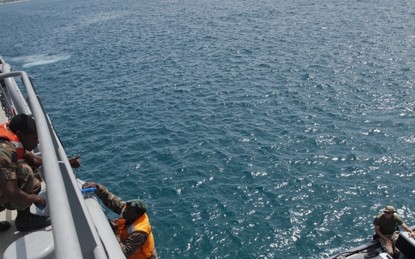 One student helps another climb a Jacob's ladder as part of maritime shipboard training during Exercise Tradewinds 2012