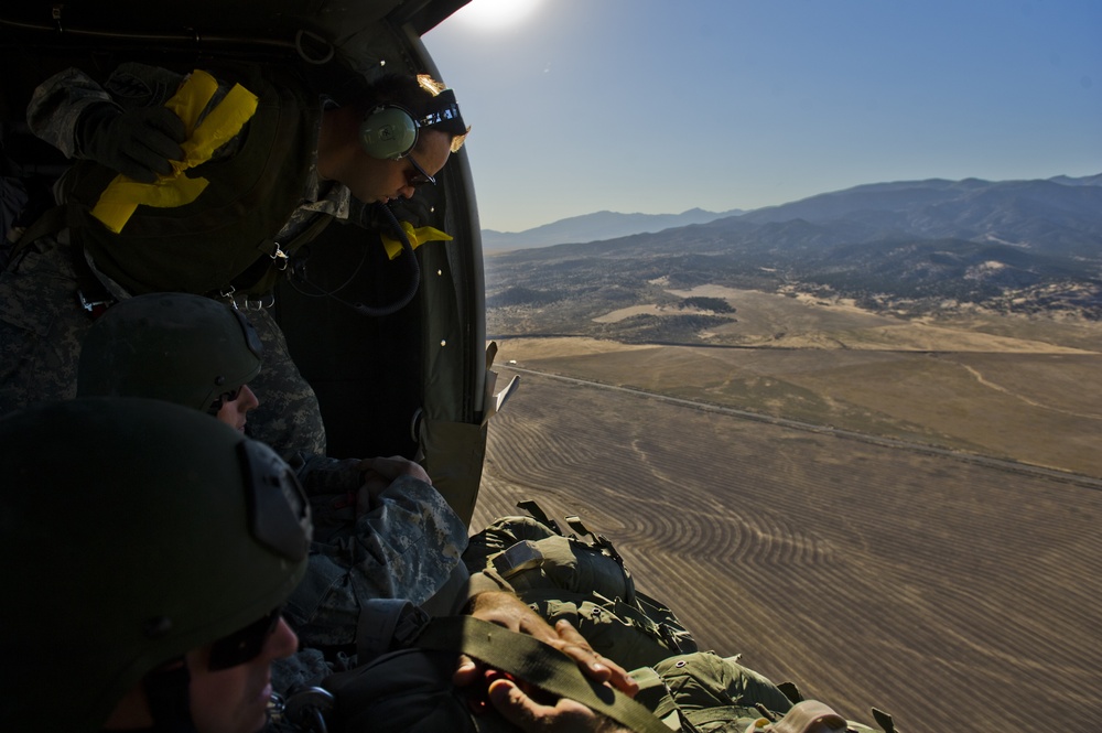 Utah Army National Guard performing static line jumps from Black Hawks