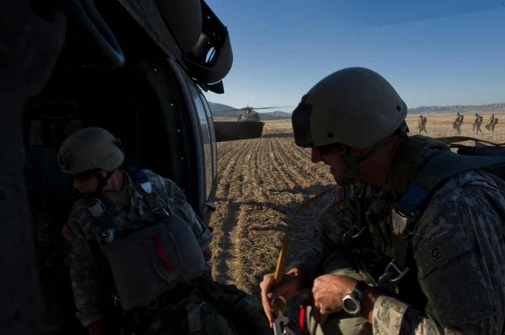 Utah Army National Guard performing static line jumps from Black Hawks