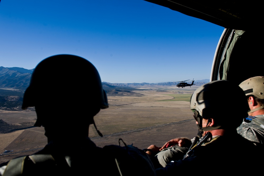 Utah Army National Guard performing static line jumps from Black Hawks