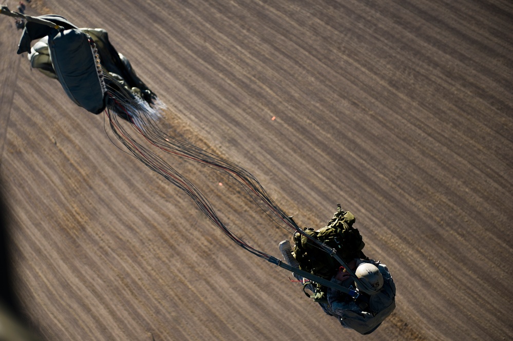 Utah Army National Guard performing static line jumps from Black Hawks