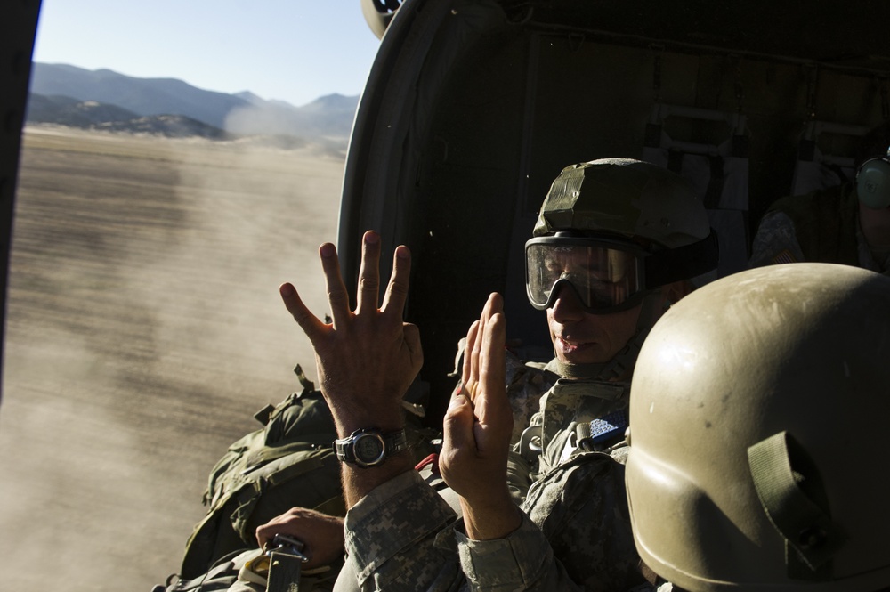 Utah Army National Guard performing static line jumps from Black Hawks