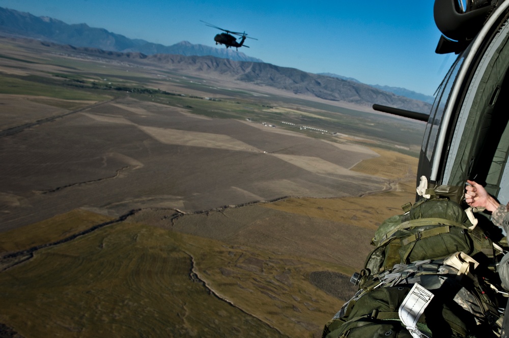 Utah Army National Guard performing static line jumps from Black Hawks