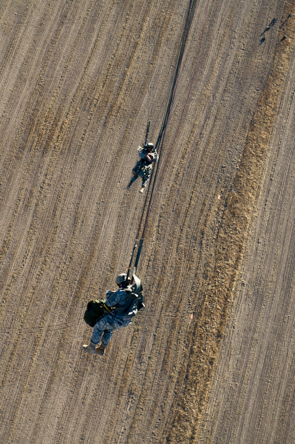 Utah Army National Guard performing static line jumps from Black Hawks