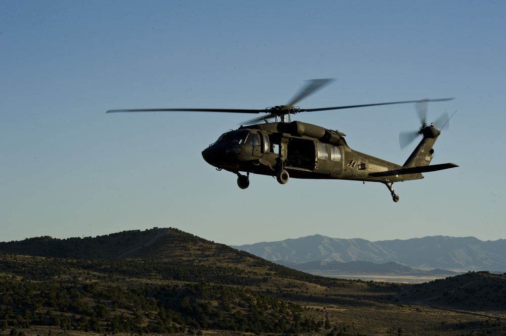 Utah Army National Guard performing static line jumps from Black Hawks