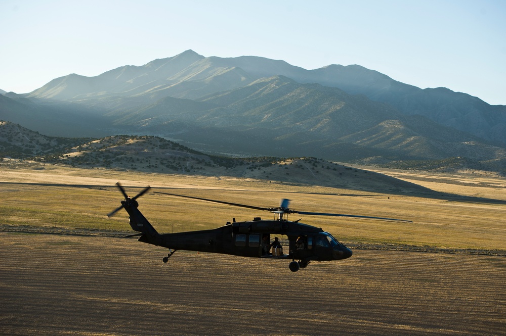 Utah Army National Guard performing static line jumps from Black Hawks