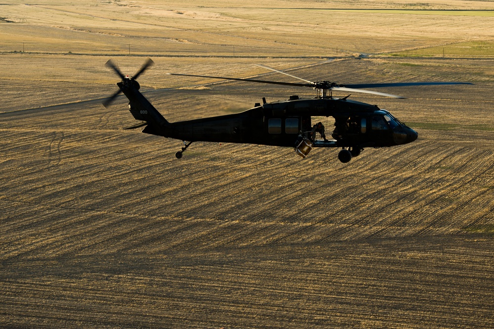 Utah Army National Guard performing static line jumps from Black Hawks