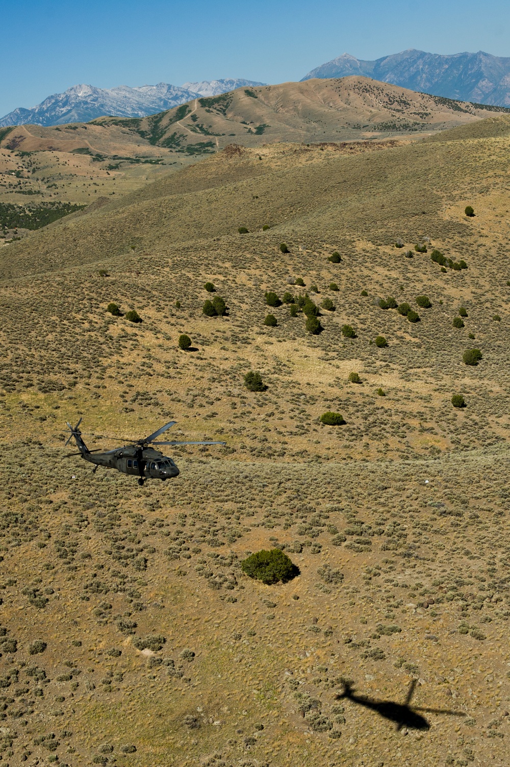 Utah Army National Guard performing static line jumps from Black Hawks