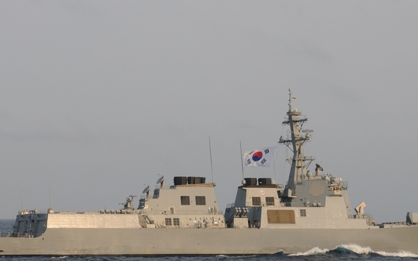 A Republic of Korea Navy destroyer is underway at sea, displaying the hull number 991 on its stern. The vessel is flying the South Korean national flag (Taegukgi) from its mast. The ship appears to be a Sejong the Great-class (KDX-III) guided-missile destroyer based on its silhouette and design characteristics.