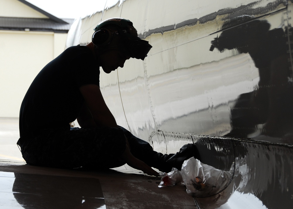 Sailor at work on P-3C Orion wing