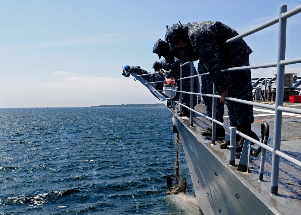 Sailors watch USS Normandy's anchor rise