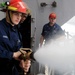 USS George H.W. Bush sailor holds fire hose