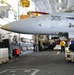 Sailor directs F/A-18C Hornet into hangar bay