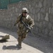 Spc. Kirk Peschke pulls a skedco litter up a hill