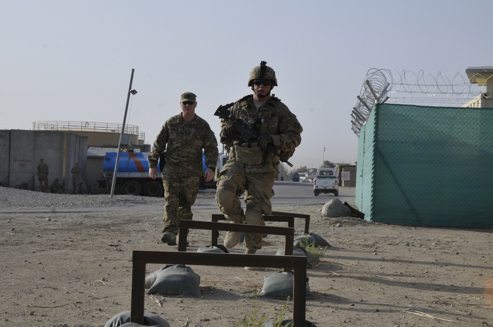 Pfc. Stephen Roph jumps hurdle