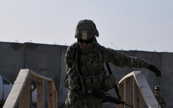 Sgt. Celina Foy drags a skedco litter across a bridge