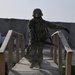 Sgt. Celina Foy drags a skedco litter across a bridge