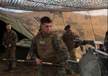 U.S. Marine and New Zealand gunners fire cannons in snowstorm to conclude Exercise Brimstone