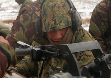 U.S. Marine and New Zealand gunners fire cannons in snowstorm to conclude Exercise Brimstone