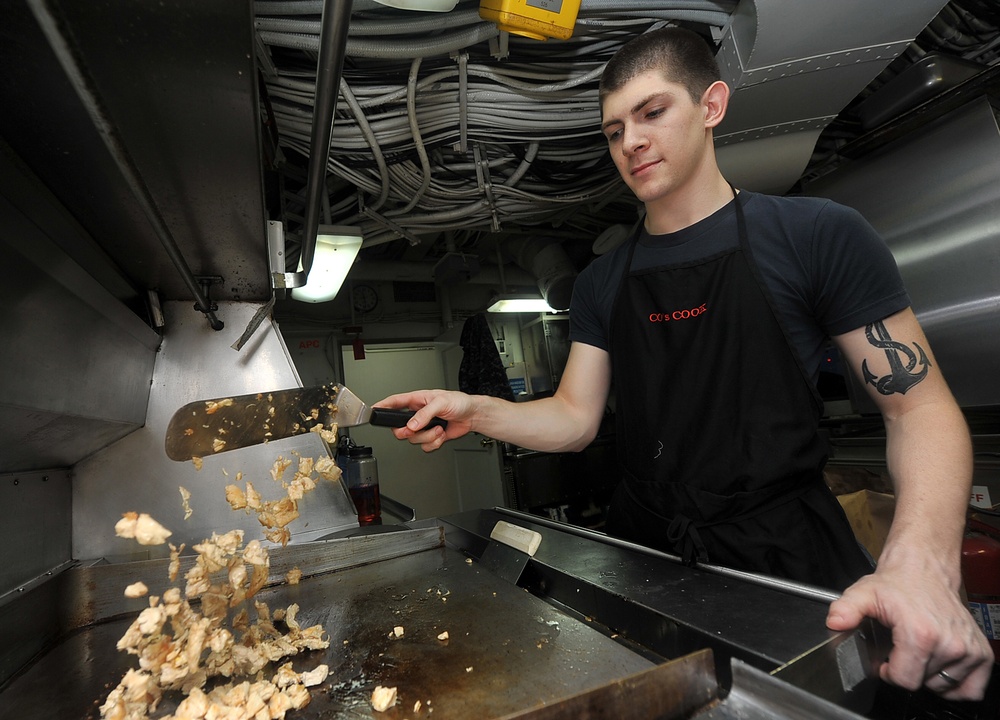 USS Abraham Lincoln sailor preps lunch