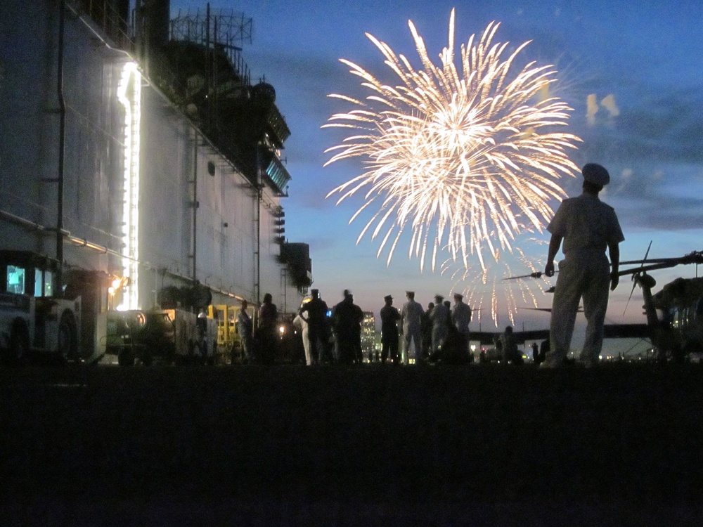 US sailors and Marines watch a fireworks display