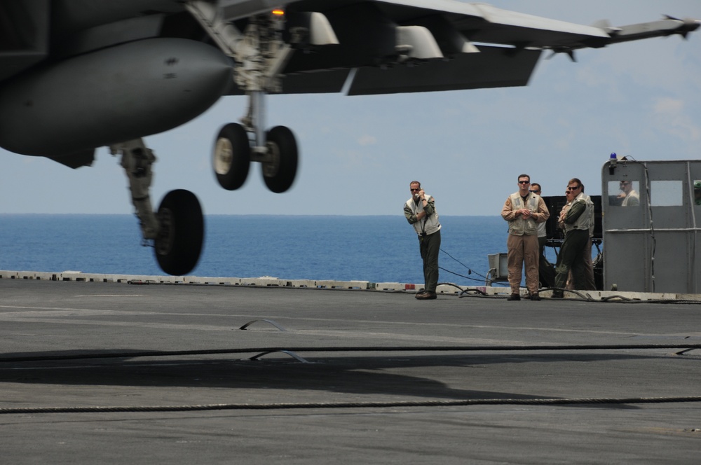 Guiding an F/A-18 onto the flight deck of USS George Washington