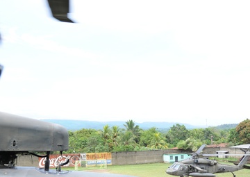 U.S. Army South Soldier looks out of aircraft during takeoff