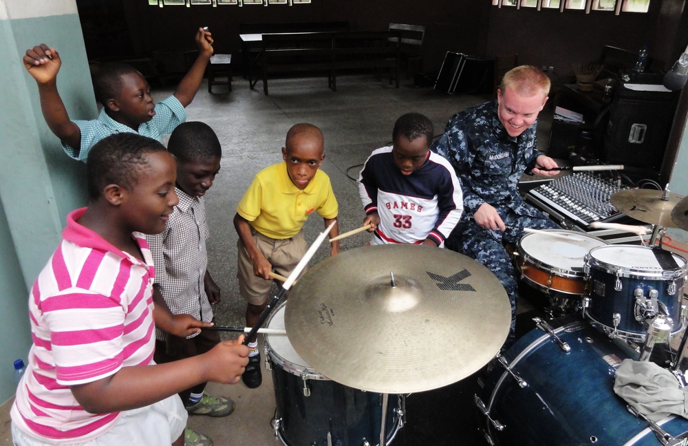 US Naval Forces Europe Band 'Topside,' performs with a musician from Benin Fire Safety Patrol Band