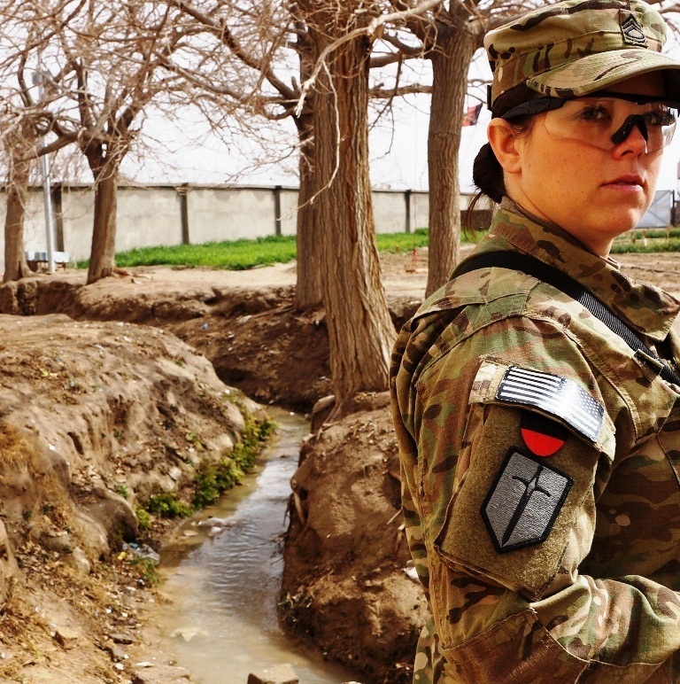 Female soldier surveys a demonstration garden in Kandahar province, Afghanistan