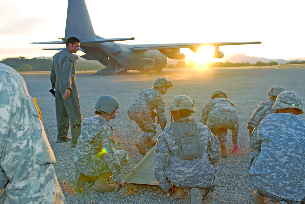 Army Reserve medics train at sunset in Fort Hunter Liggett