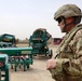 Civilian surveys farm equipment for Afghanis