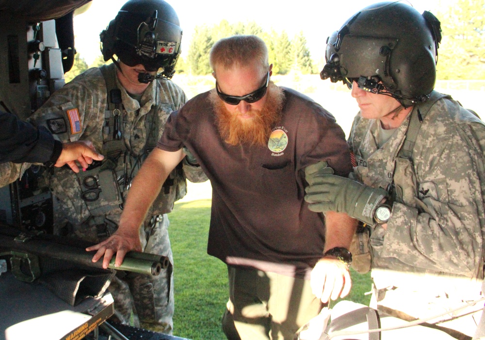 Soldiers assist heat casualty into a MEDEVAC for transport to Sutter Roseville Medical Center