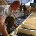 Kentucky soldier measures a building frame in Afghanistan