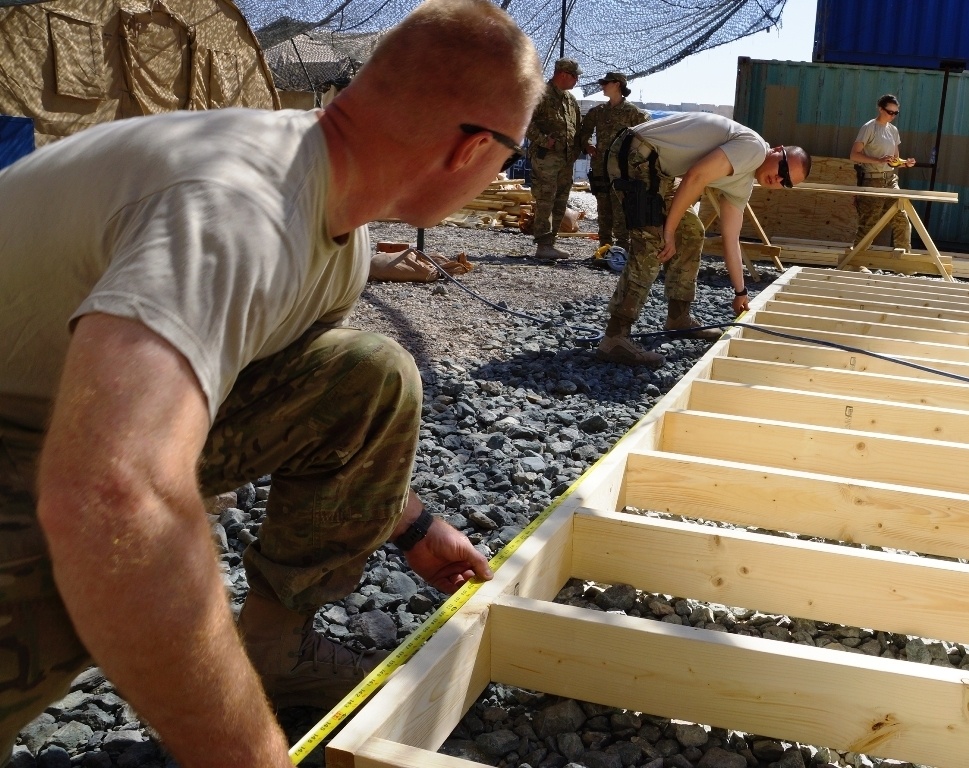 Kentucky soldier measures a building frame in Afghanistan
